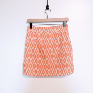 Annabella orange geometric print mini skirt with contracted zipper in the back.